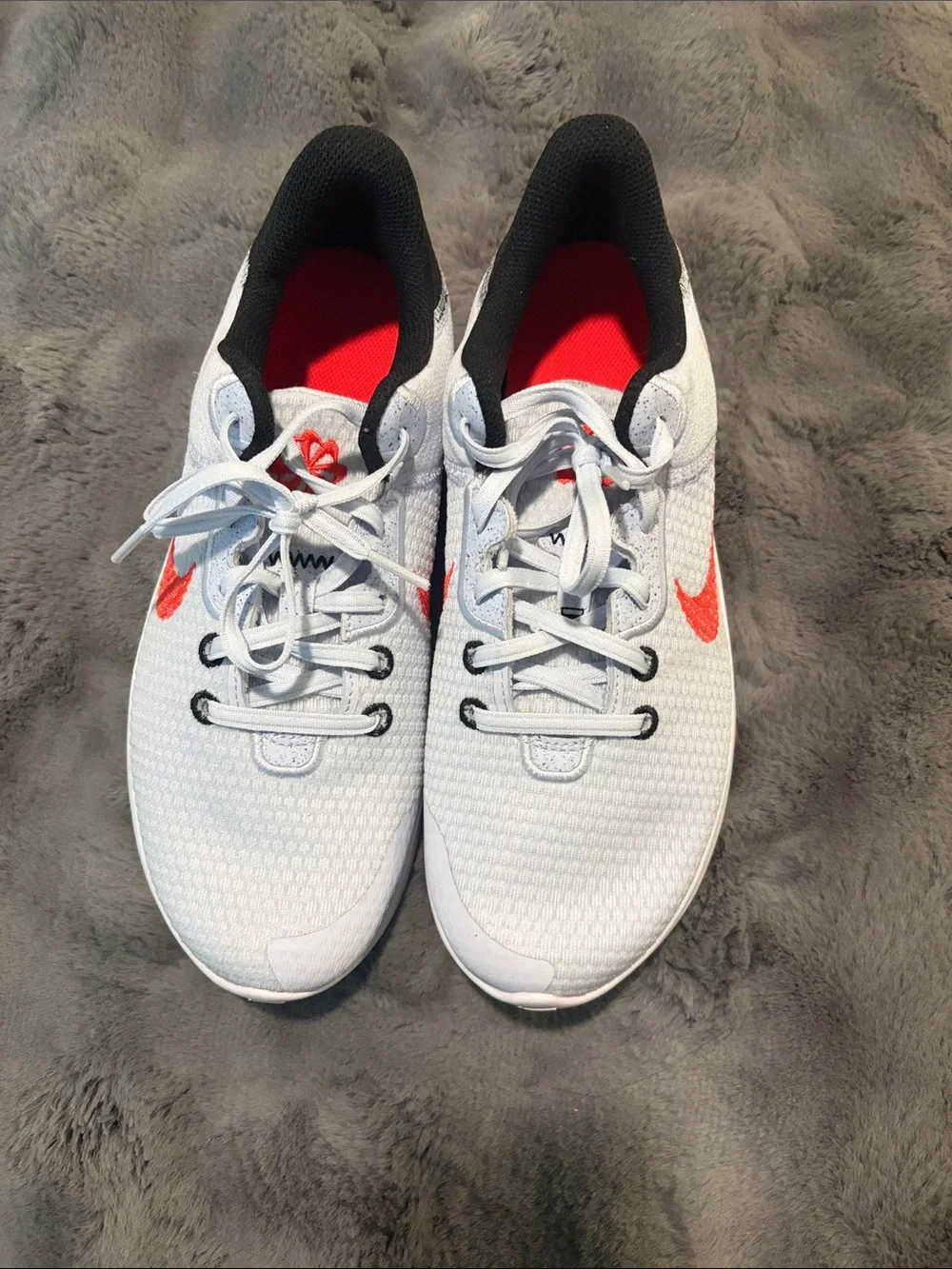 Nike Kids White Sneakers with Red Swoosh and Black Heel